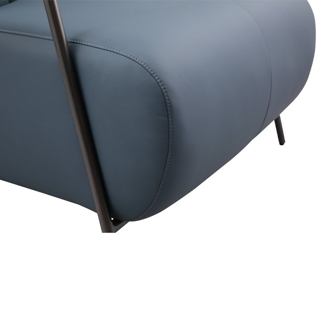 Contemporary lounge chair with soft blue upholstery, cushioned armrests, and curved black metal frame – designed for comfort in upscale hospitality or commercial spaces